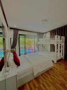 a bedroom with two bunk beds and a balcony at 784 poolvilla พูลวิลล่า in Ban Khao Rup Chang