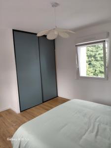a bedroom with two glass doors and a window at Kity House maison individuelle avec jardin in Neufchâteau