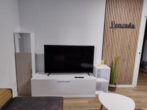 a living room with a tv on a white entertainment center at Cabañita Playa da Lanzada in Sanxenxo