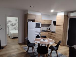 a kitchen and dining room with a table and chairs at Cabañita Playa da Lanzada in Sanxenxo