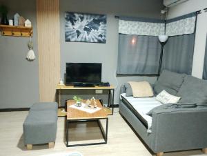 a living room with a couch and a table at UCOGUESTHOUSE - Casa de Huéspedes in Vista Flores