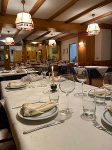 a table with wine glasses and a candle on it at Albergo Centrale in Carbonare di Folgaria