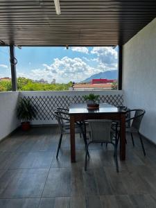 a table and chairs on a balcony with a view at Стаи за гости Крис in Vratsa