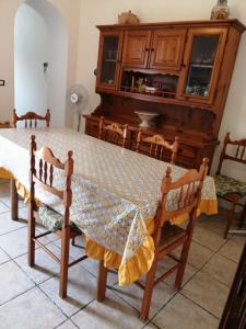 a dining room with a table and chairs at Sunset House in Castro di Lecce