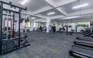 a gym with treadmills and machines in a room at Vibyqa cosy and vibes in Nairobi
