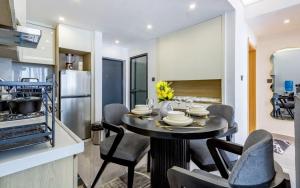 a kitchen and dining room with a table and chairs at Vibyqa cosy and vibes in Nairobi