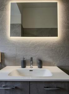 un bagno con lavandino e specchio di NEW! Vatican Domizia Apartment a Roma