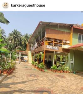 a building on a street with plants in front of it at Karkera Family Homestay in Malpe