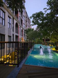 a swimming pool in the middle of a city at La Habana Huahin by J2A in Hua Hin