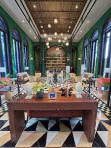 a large room with a large table in a building at La Habana Huahin by J2A in Hua Hin