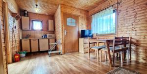 a kitchen and dining room with a table and chairs at Domek Standard 2 in Darłowo