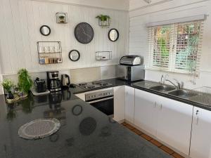 a kitchen with a sink and a stove top oven at Knysna Retreat - Knysna River Club in Knysna