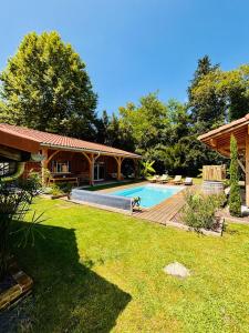 a house with a swimming pool in a yard at Villa La Forge in Parentis-en-Born +32 photos
