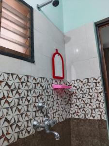a bathroom with a sink and a red mirror at Royal 2 Bed Room Apartment -Opp Mattuthavai Bus stand Madurai in Madurai +26 photos