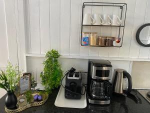 a kitchen counter with a coffee maker on a counter top at Knysna Retreat - Knysna River Club in Knysna +43 photos