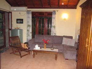 a living room with a couch and a coffee table at Mallis Guesthouse in Habaraduwa