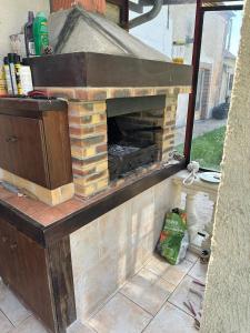 a brick fireplace on a patio with at l'Etable des Arts in Tillières-sur-Avre +2 photos