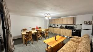 a living room with a table and a kitchen at A Frame Panoramic Dundy in Dealu Muntelui