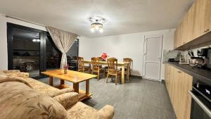 a living room with a couch and a table in a kitchen at A Frame Panoramic Dundy  +25 photos