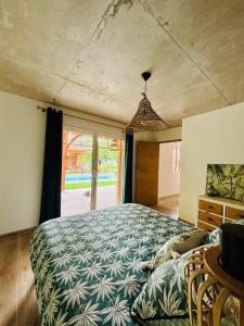 a bedroom with a large bed and a large window at Villa La Forge in Parentis-en-Born