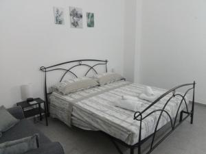 a bedroom with a bed with white sheets and pillows at Apulian Bluemoon House in Molfetta +3 photos