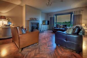 a large living room with two couches and a couch at Willan Cottage in Portrush