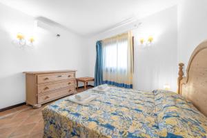 a bedroom with a bed and a dresser and a window at -Vista Mare- Casa con piscina e spiaggia a 300 MT in Liscia di Vacca +21 photos