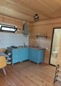 a bathroom with a blue sink in a room at Qusarion - ქუსარიონი in Agara +10 photos