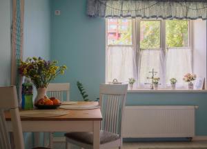 a dining room with a table and a window at Sweet-S in Boryspil +27 photos