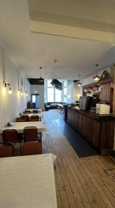 a dining room with tables and chairs and a bar at The Stromness Hotel in Stromness