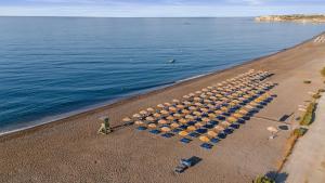 an overhead view of a beach with umbrellas at Almyra Resort in Koutsounari