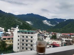 a cup of coffee sitting on top of a building at Ima Ganga Hotel - Aesthetic, Quite Mountain View Rooms In Upper Tapovan with netflix, free airport pickup for 7 or more nights booking in Rishīkesh +21 photos