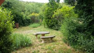 a stone bench sitting in the middle of a garden at Ô Grézac in Lodève