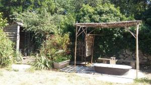 a wooden structure with a tub in a garden at Ô Grézac in Lodève