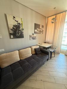 a living room with a couch and a table at Arkadia Terrace in Odesa