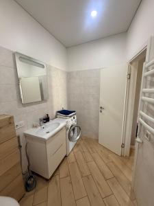 a bathroom with a washing machine and a sink at Arkadia Terrace in Odesa