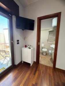 a room with a bathroom with a toilet and a mirror at House Zeta Piazza Carmine in Reggio Calabria +26 photos