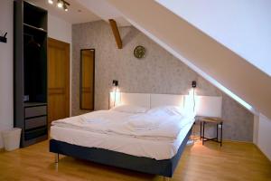 a bedroom with a bed in a room with an attic at Villa Margarita in Český Krumlov