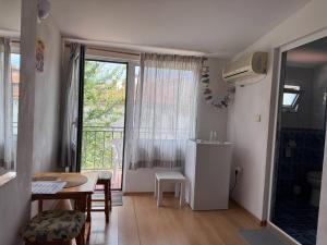 a small room with a table and a dining room at The Two Anchors in Nesebar +27 photos