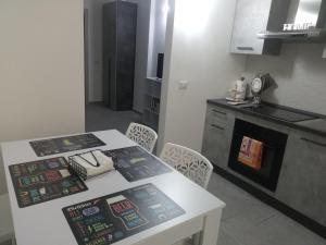 a kitchen with a table and a counter with a stove at Apulian Bluemoon House in Molfetta