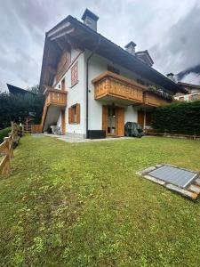 a house with a lawn in front of it at Chalet CHIARA&CARLO in Bormio