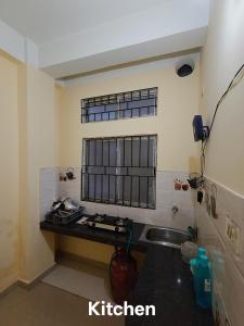 a kitchen with a sink and a window at Rent N Stay - Affordable Homestay in Guwahati in Guwahati