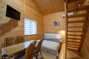 a bedroom with a bed and a table in a room at Siodemkacamp Karwia in Karwia