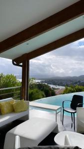 a living room with a view of a pool at Latitude vue unique in Les Trois-Îlets