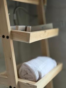 a wooden shelf with a towel on it at Museum Boutique Hotel Tirana in Tirane