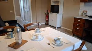 a table with cups and saucers on top of it at Casa Vacanze Stefania in Maccarese