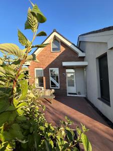 a house with a driveway in front of it at City & Nature-Amsterdam NextDoor Free parking 8 person 2 kitchens in Landsmeer
