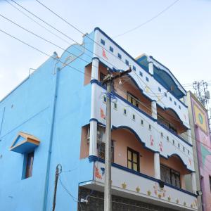 a blue building with writing on it at Raja Home stay in Tiruvannāmalai