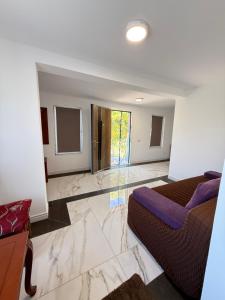 a bedroom with a bed and a couch in a room at IsTh Wave House in Vadu
