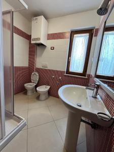 a bathroom with a sink and a toilet at Il Rifugio dell'Orso in Castel di Sangro +6 photos